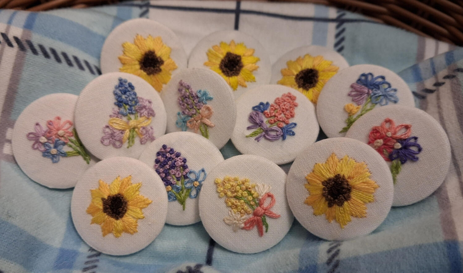 Embroidered Flower Button Badges Photograph of hand embroidered button badges.